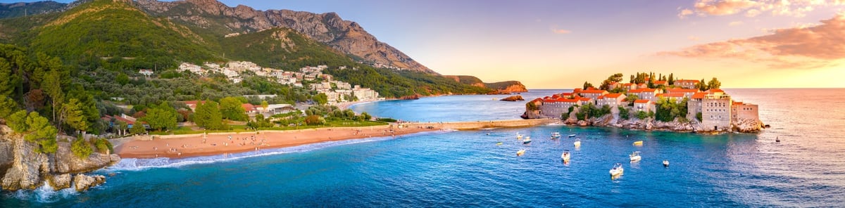 Sveti Stefan sea island, a historic stone coastal town in brilliant turquoise Adriatic waters under warm Mediterranean sunlight